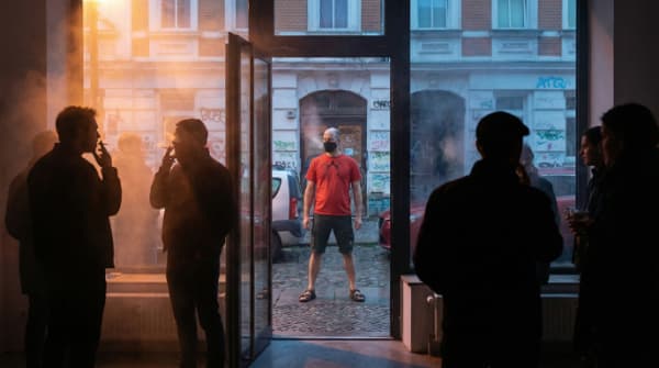 Standing outside the smoky gallery during private time, public space