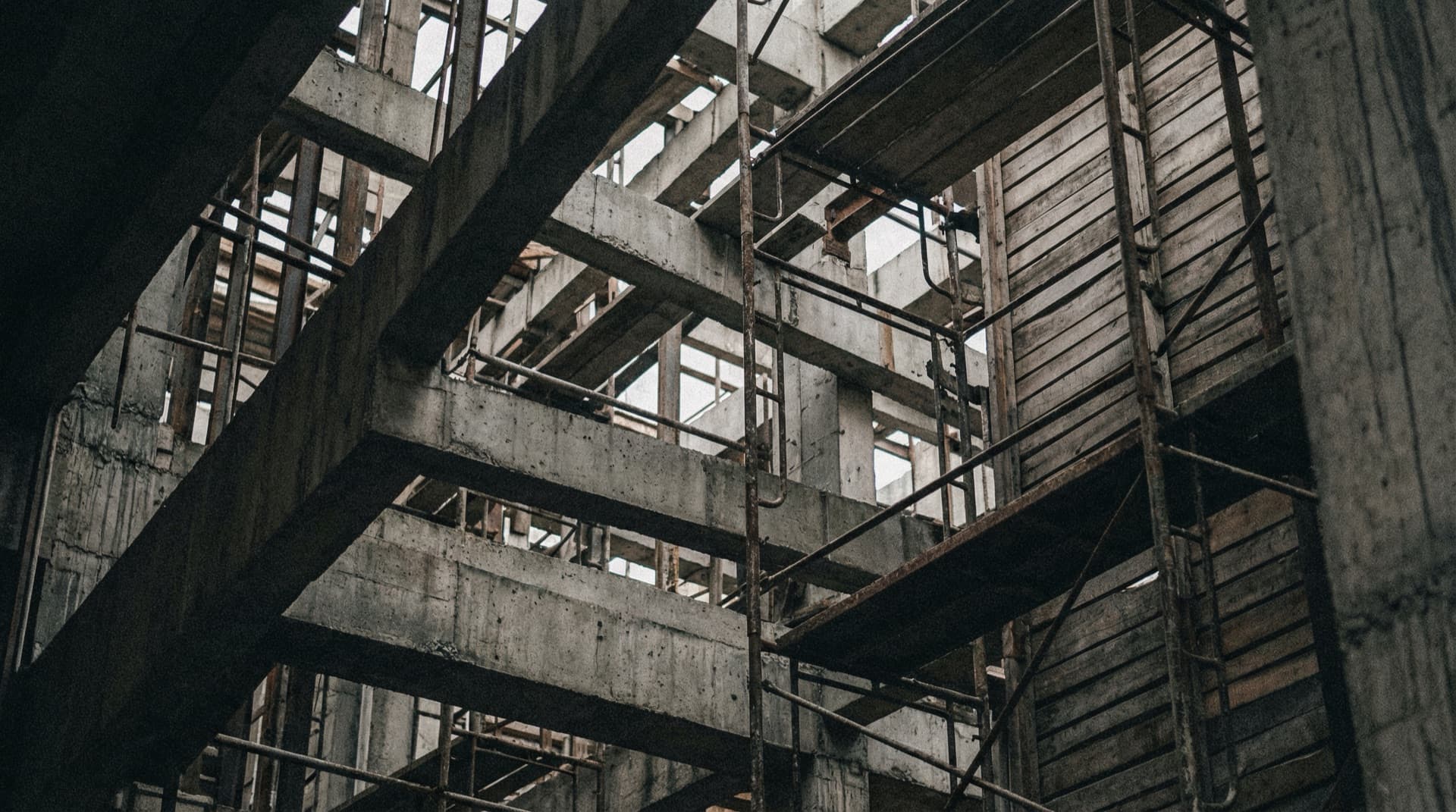 Abstract architectural grid of intersecting lines suggesting a compressed, hidden human form, with no body directly visible.